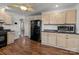 Kitchen with black appliances and wood flooring at 535 5Th St, Chester, SC 29706