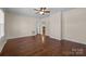 Spacious living room featuring hardwood floors, ceiling fan, and an open doorway to the kitchen at 535 5Th St, Chester, SC 29706