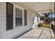 Close-up of the home's covered porch with black shutters and charming architectural details at 535 5Th St, Chester, SC 29706