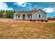 Light blue ranch home with covered porch and large yard at 5704 Bentgrass Ct, Monroe, NC 28110