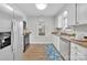 Modern kitchen with white cabinets, stainless steel appliances, and wood floor at 5704 Bentgrass Ct, Monroe, NC 28110