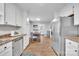 Kitchen with white cabinets, stainless steel appliances, and wood flooring at 5704 Bentgrass Ct, Monroe, NC 28110