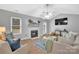 Bright living room with fireplace, hardwood floors, and ceiling fan at 5704 Bentgrass Ct, Monroe, NC 28110