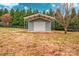 Detached storage shed with metal siding and roll-up door at 5704 Bentgrass Ct, Monroe, NC 28110