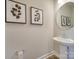 Simple bathroom with pedestal sink and framed art at 574 Altamonte Dr, Clover, SC 29710