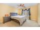 Bedroom with ceiling fan and window with sheer curtains at 6057 Erie View Ct, Denver, NC 28037