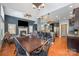 Spacious dining area with a farmhouse table and chairs, adjacent to the kitchen and living room at 6057 Erie View Ct, Denver, NC 28037