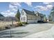 Two-car garage with driveway and landscaping at 6057 Erie View Ct, Denver, NC 28037