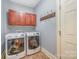 Convenient laundry room with washer, dryer, and ample cabinet storage at 6057 Erie View Ct, Denver, NC 28037