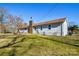 Backyard with a brick chimney and mature trees at 6615 Love Mill Rd, Monroe, NC 28110