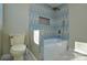 Stylish bathroom with blue and beige tile, a bathtub and a toilet at 6615 Love Mill Rd, Monroe, NC 28110