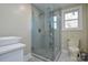 Elegant bathroom with gray tile shower, a toilet, and a white vanity at 6615 Love Mill Rd, Monroe, NC 28110