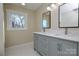 Double vanity bathroom with gray cabinets and white quartz countertops at 6615 Love Mill Rd, Monroe, NC 28110