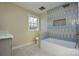 Bathroom with a tub and blue tile shower surround at 6615 Love Mill Rd, Monroe, NC 28110