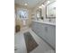 Bathroom with a double vanity, gray cabinets, white countertops, and two mirrors at 6615 Love Mill Rd, Monroe, NC 28110