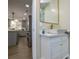 Modern bathroom with a floating vanity, a view of the kitchen, and a gold mirror at 6615 Love Mill Rd, Monroe, NC 28110