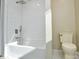 Clean bathroom features shower/bathtub combination, toilet, and white tiled walls at 6615 Love Mill Rd, Monroe, NC 28110