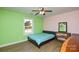 Bedroom with light green and pink walls, a window and ceiling fan at 6615 Love Mill Rd, Monroe, NC 28110