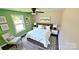 Bedroom featuring a queen bed, a ceiling fan, and a window view at 6615 Love Mill Rd, Monroe, NC 28110
