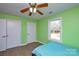 Bright bedroom with light green walls, wood floors, and a view of the backyard at 6615 Love Mill Rd, Monroe, NC 28110