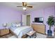 Bedroom showcasing a cozy bed, soft lavender walls, and natural light, creating a restful atmosphere at 6615 Love Mill Rd, Monroe, NC 28110