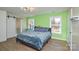 Bedroom with large windows, bright green walls, and ceiling fan at 6615 Love Mill Rd, Monroe, NC 28110