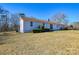 Ranch style home with a brown roof and a well-maintained lawn at 6615 Love Mill Rd, Monroe, NC 28110