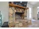 Stone fireplace with wooden mantel and hearth in a cozy living space at 6615 Love Mill Rd, Monroe, NC 28110