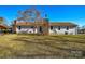 Rear view of a ranch style home with brick chimney and landscaping at 6615 Love Mill Rd, Monroe, NC 28110