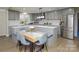 Modern kitchen with gray cabinets, stainless steel appliances, breakfast bar, and a dining area at 6615 Love Mill Rd, Monroe, NC 28110