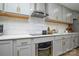 Close-up of a modern kitchen with sleek appliances, quartz countertops, and gray cabinets at 6615 Love Mill Rd, Monroe, NC 28110