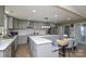 Spacious kitchen featuring gray cabinets, stainless steel appliances, and a cozy dining nook at 6615 Love Mill Rd, Monroe, NC 28110