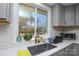 Modern kitchen sink with gold faucet and large window at 6615 Love Mill Rd, Monroe, NC 28110