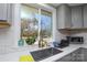 Kitchen sink with a window view, quartz countertops, and gray cabinets at 6615 Love Mill Rd, Monroe, NC 28110