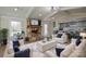 Open concept living room featuring stone fireplace, modern lighting, and a seamless flow into the adjacent kitchen at 6615 Love Mill Rd, Monroe, NC 28110