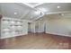 Bright living room featuring a decorative ceiling, recessed lighting and wood flooring at 6615 Love Mill Rd, Monroe, NC 28110