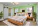 Serene main bedroom with a king bed, stylish lighting, and ensuite bathroom access at 6615 Love Mill Rd, Monroe, NC 28110
