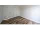 Bedroom with wood-look floors and double doors at 7151 Stonington Ln, Charlotte, NC 28227