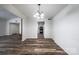 Open dining room with wood-look floors and access to the kitchen at 7151 Stonington Ln, Charlotte, NC 28227