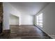 Sunlit living room with hardwood floors and a stone fireplace at 7151 Stonington Ln, Charlotte, NC 28227