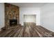 Bright living room with a large stone fireplace and hardwood floors at 7151 Stonington Ln, Charlotte, NC 28227