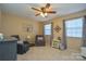 Bright bedroom with ceiling fan, two armchairs, and ample natural light at 7608 Woods Ln # 12, Cornelius, NC 28031