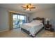 Bedroom with ceiling fan and private balcony access at 7608 Woods Ln # 12, Cornelius, NC 28031