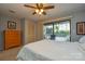 Bedroom with ceiling fan, dresser and private balcony access at 7608 Woods Ln # 12, Cornelius, NC 28031