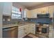 Galley kitchen with stainless steel appliances and granite countertops at 7608 Woods Ln # 12, Cornelius, NC 28031