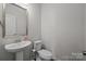 Clean and modern bathroom with pedestal sink and toilet at 7840 Denmark Rd, Charlotte, NC 28273