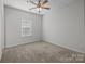 Bright bedroom featuring neutral walls and carpeted floors at 7840 Denmark Rd, Charlotte, NC 28273