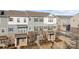 Front view of charming townhouses with gray siding and brick accents at 7840 Denmark Rd, Charlotte, NC 28273