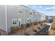 Rear view of townhouses showcasing private garages and wooden decks at 7840 Denmark Rd, Charlotte, NC 28273