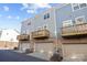 Rear view of townhouses showcasing private garages and wooden decks at 7840 Denmark Rd, Charlotte, NC 28273